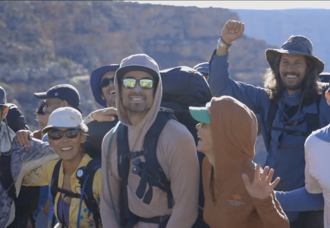 Smiling Camp Omega backpackers celebrating together in the high desert