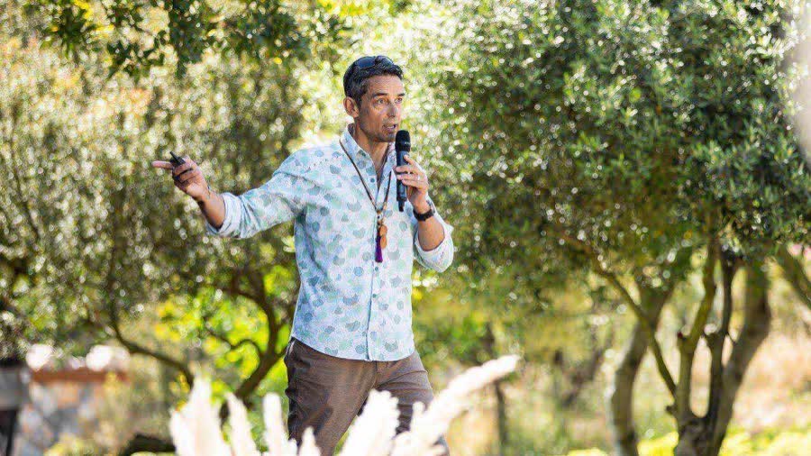 Jamie Wheal teaching outdoors among olive trees