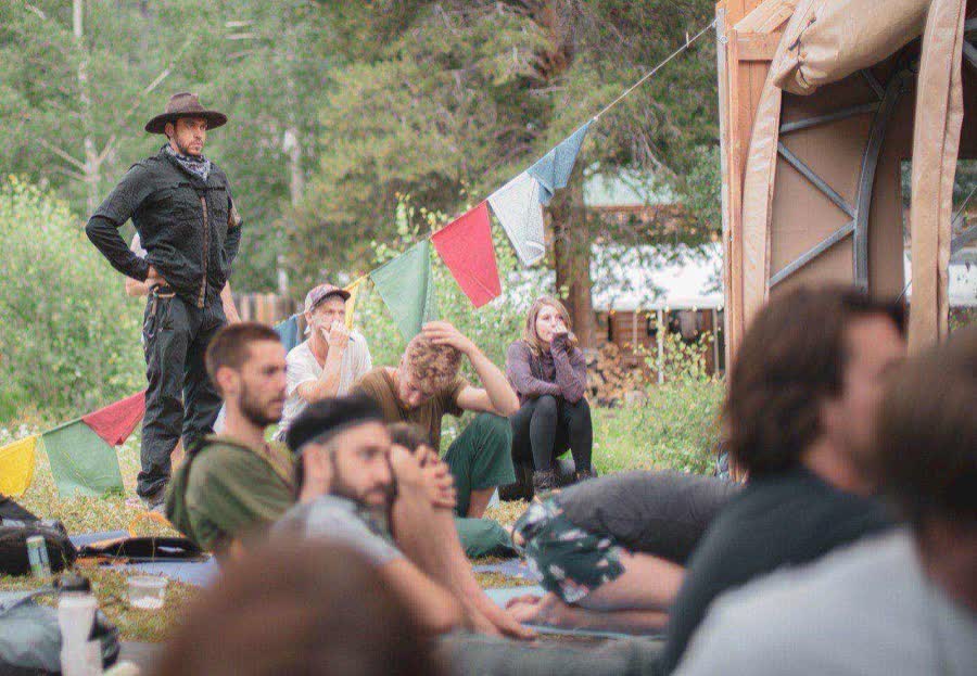 Campers gathered for a seminar under prayer flags